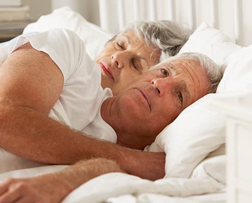 older couple laying in bed