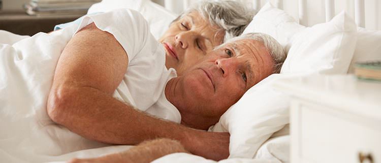 older couple laying in bed