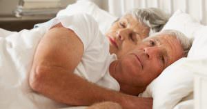 older couple laying in bed