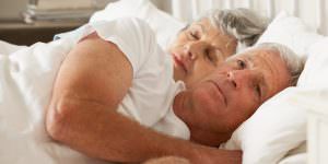 older couple laying in bed