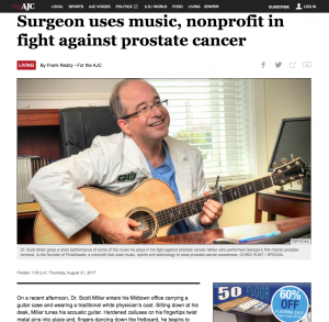 Dr. Scott Miller holding a guitar